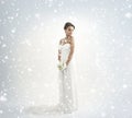 A bride in a white dress on a snowy background