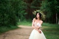 Bride in a white dress with a wreath of flowers