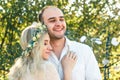 Bride in white dress and wreath and groom portrait in sunny summer day. Rustic outdoor wedding concept. Soft focus Royalty Free Stock Photo