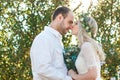 Bride in white dress and wreath and groom portrait in sunny summer day. Rustic outdoor wedding concept Royalty Free Stock Photo