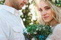 Bride in white dress and wreath and groom portrait in sunny summer day. Rustic outdoor wedding concept Royalty Free Stock Photo