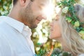 Bride in white dress and wreath and groom portrait in sunny summer day. Rustic outdoor wedding concept Royalty Free Stock Photo