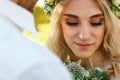 Bride in white dress and wreath and groom portrait in sunny summer day. Rustic outdoor wedding concept Royalty Free Stock Photo