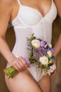 Bride in a white underwear with a wedding bouquet