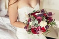 Bride in white wedding dress holding lilac wedding bouquet Royalty Free Stock Photo