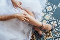 Bride in white wedding dress putting on silver shoes Royalty Free Stock Photo