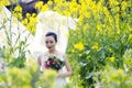 Bride with white wedding dress in flower field Royalty Free Stock Photo