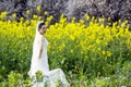 Bride with white wedding dress in flower field Royalty Free Stock Photo