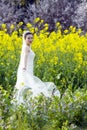 Bride with white wedding dress in flower field Royalty Free Stock Photo