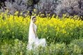 Bride with white wedding dress in flower field Royalty Free Stock Photo