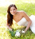 Bride woman lying in park grass