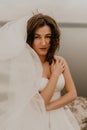 bride woman with short haircut in white wedding corset dress strapless and with a long chiffon veil on head Royalty Free Stock Photo