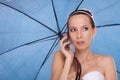 Bride woman with umbrella talking on mobile phone. Royalty Free Stock Photo