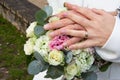 Bride woman in white marriage dress holding in hand wedding bouquet flowers with groom hands marriage rings golden Royalty Free Stock Photo