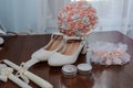 Bride& x27;s accessories. Women& x27;s shoes leather, garter, bridal bouquet, candles, pendant Royalty Free Stock Photo