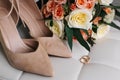 bride& x27;s bouquet, beige shoes and wedding rings. The bride& x27;s accessories. Royalty Free Stock Photo
