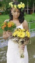 A bride with a yellow flower wreath holding two bouquets. Royalty Free Stock Photo