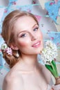 Bride. Young fashion model with perfect skin and make up, flowers in hair. Beautiful woman with makeup and hairstyle in bedroom. Royalty Free Stock Photo