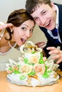 Bridegroom and bride with wedding cake