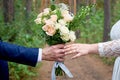 Bridegroom gives the bride a wedding bouquet for a walk in the park Royalty Free Stock Photo