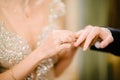The bridegroom puts the wedding ring on the bride close up. The bride puts the bridegroom on the wedding ring Royalty Free Stock Photo