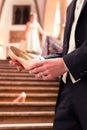 Bridegroom`s hand holding bride`s wedding shoe Royalty Free Stock Photo