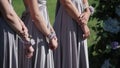 Bridemaids in blue gray dresses staying at wedding ceremony outdoors