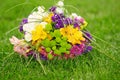 Brides bouquet of colorful flowers lying on a green lawn. Royalty Free Stock Photo