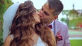 Brides kissing near medieval wall with ivy. slow motion handy camera motion style