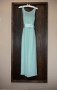 bridesmaid blue dress hanging from a hook
