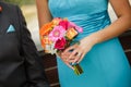 Bridesmaid and groomsman walking down the aisle with colorful bo