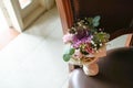 Bridesmaid hand flower bouquet on the chair Royalty Free Stock Photo