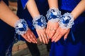 Bridesmaid hands closeup in blue dresses together