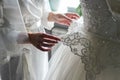 Bridesmaid holding bride`s wedding dress Royalty Free Stock Photo