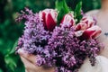 Bridesmaid holding purple wedding bouquet against dress Royalty Free Stock Photo