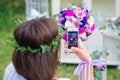 Bridesmaid photographing a wedding bouquet on the phone. Florist