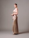 Bridesmaid`s dresses. Elegant moscato dress. Beautiful ivory silk evening gown. Studio portrait of young happy ginger woman. Tran