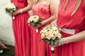 Bridesmaid the same dressed with bouquets of roses and other flo Royalty Free Stock Photo
