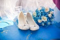 Bridesmaid shoes and blue bouquet