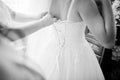 Bridesmaid tie ribbon on back of wedding dress on bride. Black a Royalty Free Stock Photo