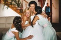 Bridesmaids embracing a charming bride Royalty Free Stock Photo