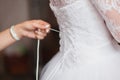 Bridesmaids helping to tie her wedding dress. tradition, the bride morning Royalty Free Stock Photo