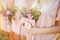 Bridesmaids in pink dresses with bouquets Royalty Free Stock Photo