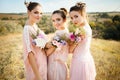 Bridesmaids in pink dresses with bouquets Royalty Free Stock Photo