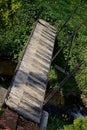 Bridge across garden water stream painted as piano keys Royalty Free Stock Photo