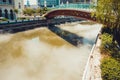 Bridge across Gombak river. Misty water. Kuala Lumpur cityscape. Connection concept. Travel to Malaysia. River embankment. City to Royalty Free Stock Photo