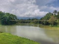 A bridge amongst a lake and trees and a blue sky as a background Royalty Free Stock Photo