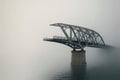 A bridge that breaks off in the fog over the water. Space for text. Royalty Free Stock Photo