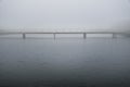 Bridge in calm peaceful misty weather in white dreamy landscape