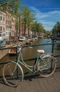 Bridge on canal with bicycle stuck at banister Royalty Free Stock Photo